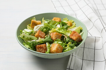 Fried tofu salad in a bowl on a white background