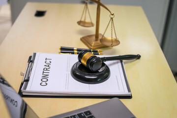 In an empty office, a lawyer's desk is filled with legal documents, contracts, and a laptop. The scene symbolizes the intersection of law, business, finance, and justice