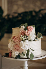 white wedding cake decorated by flowers