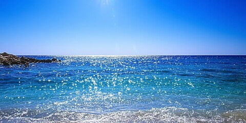 A sparkling blue sea under a clear sky