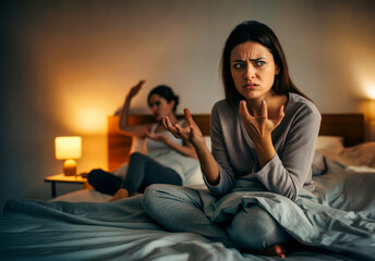 Fototapeta premium Two women, angry and conflict of couple in bedroom with stress, breakup and frustrated at home