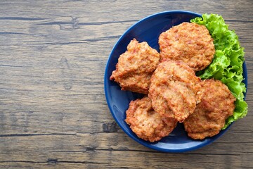 fried minced pork in a blue plate , thai food , home cooked ,Thai cuisine	, top view food table