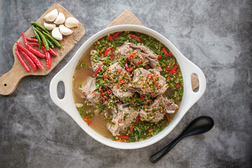 Spicy Pork Back-Bone Stew topped with sliced ​​green and red chili peppers, seasoned with lime, garlic, It has a sour and spicy but delicious taste.