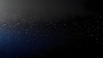 Obraz premium A textured surface with droplets against a dark background.