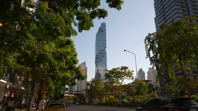sunny evening bangkok city center famous skyscraper tower exterior traffic street slow motion view 4k thailand