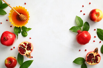 Rosh Hashanah Jewish holiday concept. Flat lay honey with apple and pomegranate on white stone desk, top view frame with copy space