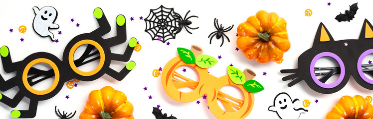 Halloween banner with kids party accessories, eyeglasses and decor on white background.