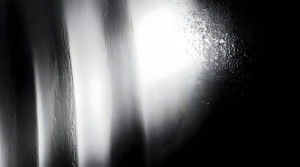 Abstract black and white image with fluid textures and reflections.