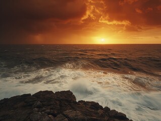 Fototapeta premium A scenic view of ocean rocks and seascape under an orange sky, showcasing natural beauty and serene atmosphere
