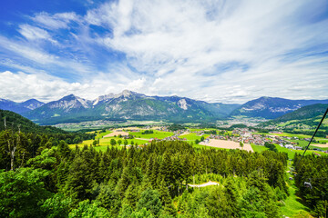 Naklejka premium View from the Reiterkogel mountain near Saalbach Hinterglemm. Landscape on the mountain with the surrounding nature. Mountain group of the Kitzbühel Alps. 