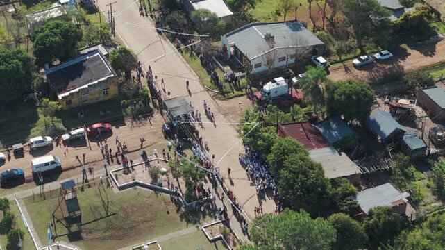Overlooking panning shot from Argentine flag ceremony and dancing chacarera.