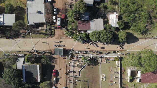 High-angle shot or drone overlooking people on the ground at the Argentine flag ceremony and dancing chacarera