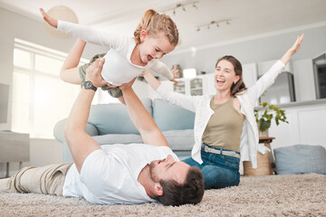 Happy family, flying and bonding with daughter on floor in living room for fun weekend or holiday...
