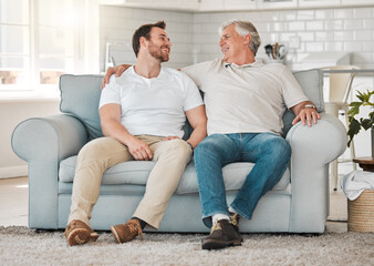 Laughing, senior father and man on sofa for talking, connection and bonding together with hug in home. Happy family, elderly dad and adult son on couch with smile, support and security in house