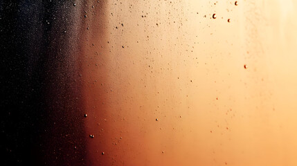 Close-up of condensation on a glass with a warm gradient background.