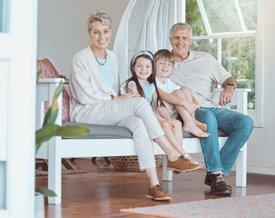 Grandparents, grandkids and portrait on sofa in home with embrace, bonding and weekend visit with smile. Happy family, senior people and children on couch with relax, retirement fun or love in lounge