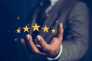 Businessman holding golden five stars for client customer feedback and evaluation after use service and product concept.