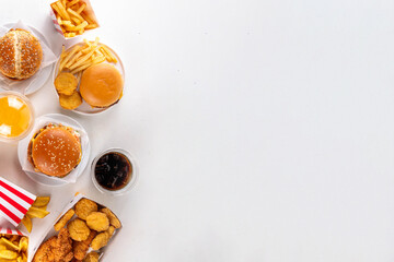 Fast food delivery menu background with various burgers, cheeseburger, nuggets, french fries, fizzy soda drinks. Junk unhealthy fast food, Ultra processed food with low nutrition, high calories value