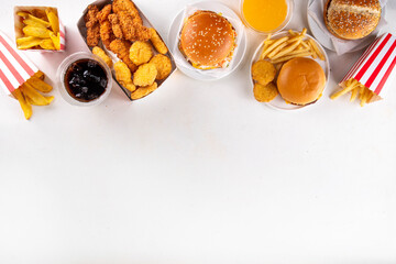 Fast food delivery menu background with various burgers, cheeseburger, nuggets, french fries, fizzy soda drinks. Junk unhealthy fast food, Ultra processed food with low nutrition, high calories value