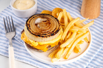 Flying Dutchman Onion Wrapped viral trendy Burger. Homemade cheeseburger with Onion Bun, nuggets and french fries