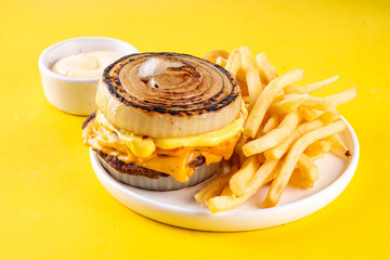 Flying Dutchman Onion Wrapped viral trendy Burger. Homemade cheeseburger with Onion Bun, nuggets and french fries