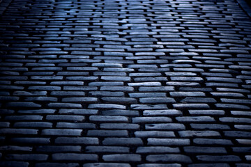 Cobblestone street on “Montmartre Place du Tertre “in Paris, France. Dark historic basalt...