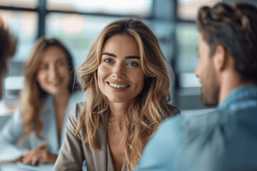 Fototapeta premium Blonde Woman Smiling In Business Meeting With Colleagues In Professional Office Setting