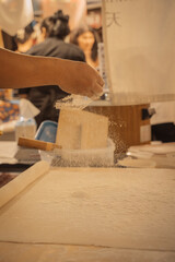 Making fresh soba noodles in a Thai market 