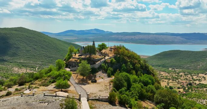 Aerial view over the Crkva Na Valu Vracenovici church, in sunny Montenegro