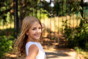 a young girl in a white dress is smiling and posing for a photo.