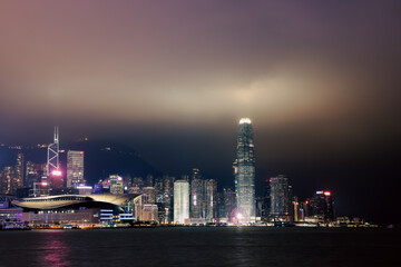 Obraz premium Nighttime panorama of bright Hong Kong harbor showcasing city skyline and illuminated buildings