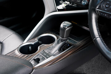 Naklejka premium automatic transmission shift selector in the car interior. Closeup a manual shift of modern car gear shifter. 4x4 gear shift