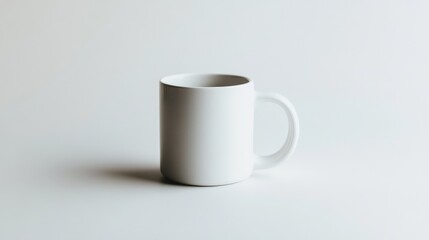 A simple white mug on a white surface, focusing on the beauty of minimal design.