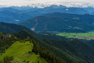 Fototapeta premium A view to the green Chiemgau nature while hiking 