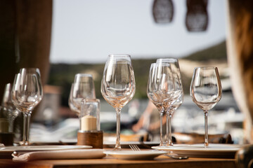 wine glasses on table in fancy restaurant by the sea