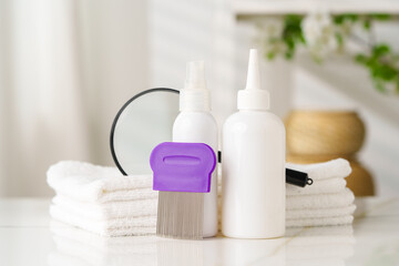 Lice treatment product next to a nit comb and magnifying glass