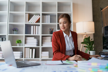 woman meticulously plans a finance audit, using a computer and calculator to review budget...