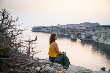 woman watching the sunset over the Town of Bonifacio  Corsica Island  France