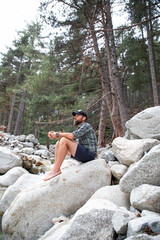 man hiker relaxing in the mountains