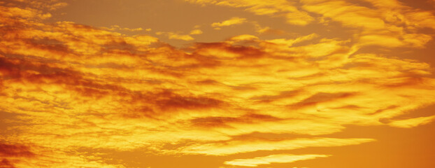 Golden cloudy sky at sunset. Sky texture. Abstract nature background