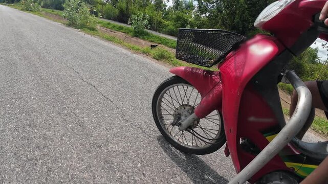 Motorcycle sidecar riding on asphalt road by canal