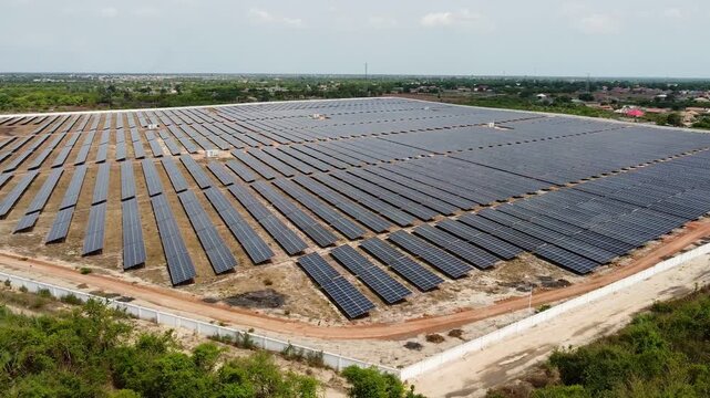 Huge array of bifacial solar PV panels at Jambur power station, Africa aerial view