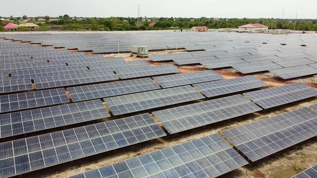 Aerial reverse view of solar PV power plant in Jambur, Africa