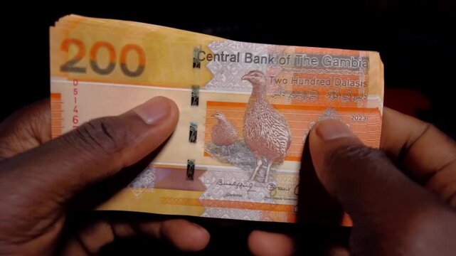 Decking and stacking Gambian Dalasi cash notes