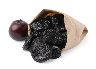 Paper bag with delicious prunes and fresh ripe plum isolated on white