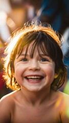 Portrait of a cheerful preschool child, smiling brightly and laughing while looking at the camera...