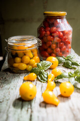 red and yellow cherry tomatoes in a jar for winter