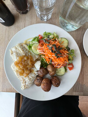 Reykjavik, Iceland - fresh steamed cod fish dish served with green salad, potatoes and a house onion sauce