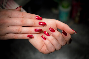 Woman's hands with red nails after manicure