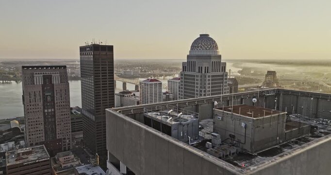 Louisville Kentucky Aerial v65 flyover downtown capturing urban cityscape, waterfront arena, bridges over the river and views of Jeffersonville at sunrise - Shot with Mavic 3 Pro Cine - Sept 26th 2023